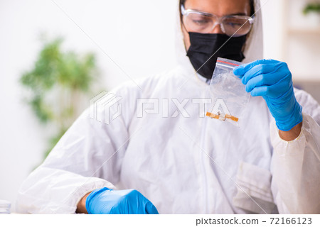 Male expert criminologist working in the lab for evidence 72166123