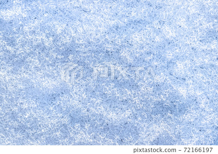 Top view of snow crystals illuminated by sunlight. Winter background. Top view of snow crystals illuminated by sunlight. Winter background. 72166197