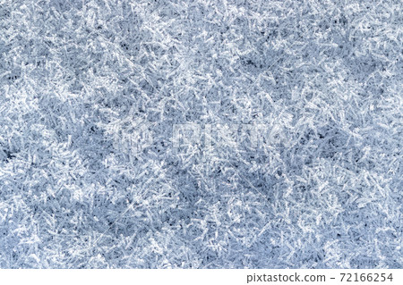 Top view of snow crystals illuminated by sunlight. Winter background. Top view of snow crystals illuminated by sunlight. Winter background. 72166254