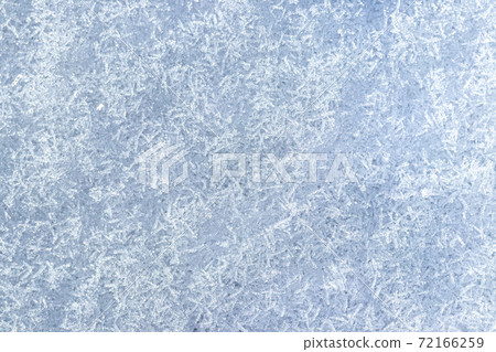 Top view of snow crystals illuminated by sunlight. Winter background. Top view of snow crystals illuminated by sunlight. Winter background. 72166259