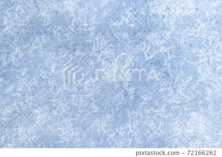 Top view of snow crystals illuminated by sunlight. Winter background. 72166262