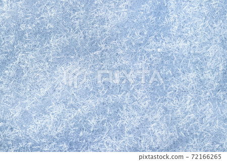 Top view of snow crystals illuminated by sunlight. Winter background. 72166265