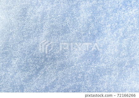 Top view of snow crystals illuminated by sunlight. Winter background. Top view of snow crystals illuminated by sunlight. Winter background. 72166266