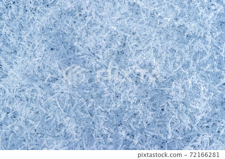 Top view of snow crystals illuminated by sunlight. Winter background. 72166281