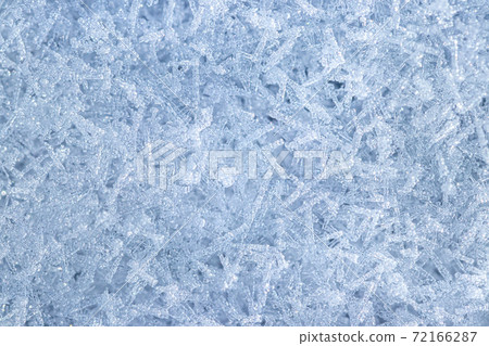Top view of snow crystals illuminated by sunlight. Winter background. Top view of snow crystals illuminated by sunlight. Winter background. 72166287