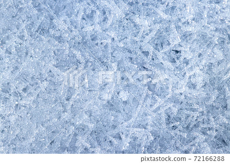 Top view of snow crystals illuminated by sunlight. Winter background. 72166288