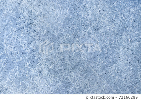 Top view of snow crystals illuminated by sunlight. Winter background. 72166289