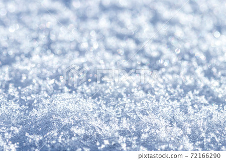 Snow crystals illuminated by sunlight. Winter background. 72166290