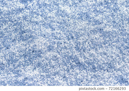 Top view of snow crystals illuminated by sunlight. Winter background. 72166293