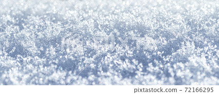Snow crystals illuminated by sunlight. Winter background. 72166295