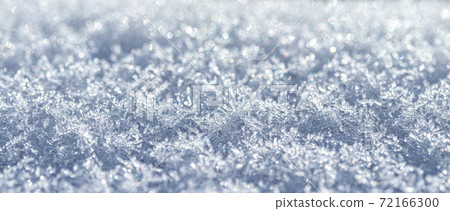 Snow crystals illuminated by sunlight. Winter background. Snow crystals illuminated by sunlight. Winter background. 72166300