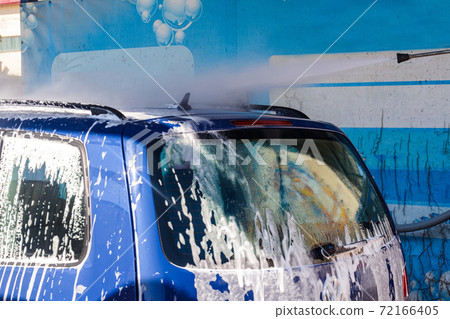 Foam on the car, car wash, self-service at the car wash, washing the car with foam. 72166405