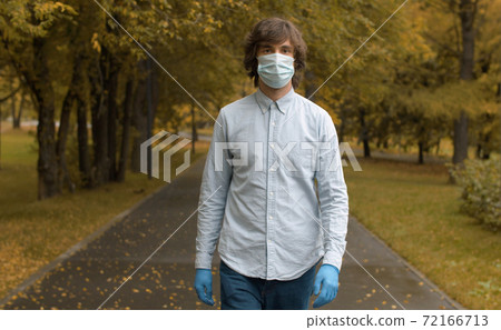 Man in mask walking in the park 72166713