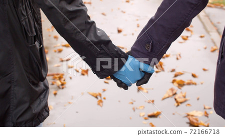 Couple walking hand by hand Couple walking hand by hand 72166718