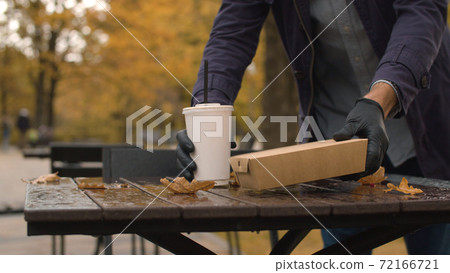 A man placing fast food on the table 72166721