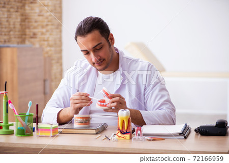 Young male dentist working in the clinic Young male dentist working in the clinic 72166959