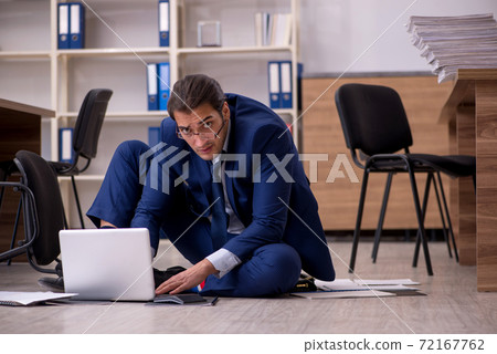 Young male businessman employee unhappy with his work Young male businessman employee unhappy with his work 72167762