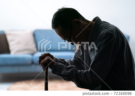 Silhouette of a senior man worried about holding a cane 72168096
