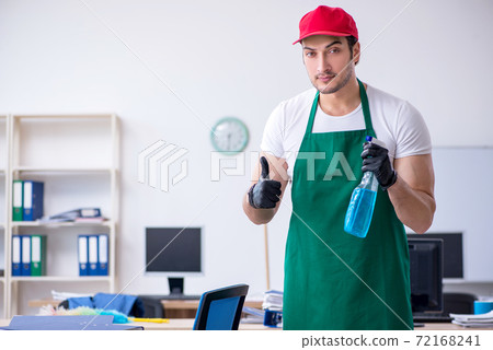 Young male contractor cleaning the office Young male contractor cleaning the office 72168241