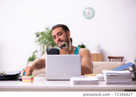 Young man working from house during pandemic Young man working from house during pandemic 72168827