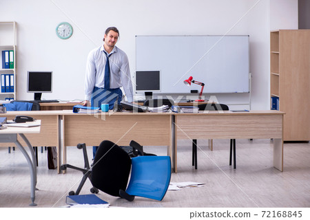 Young male employee unhappy with excessive work Young male employee unhappy with excessive work 72168845