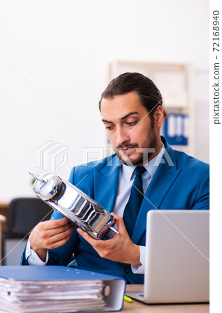 Young male employee in time management concept 72168940