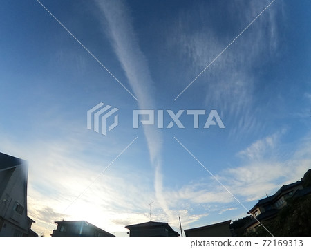 Contrails extending into the blue sky Contrails extending into the blue sky 72169313