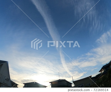 Contrails extending into the blue sky 72169314