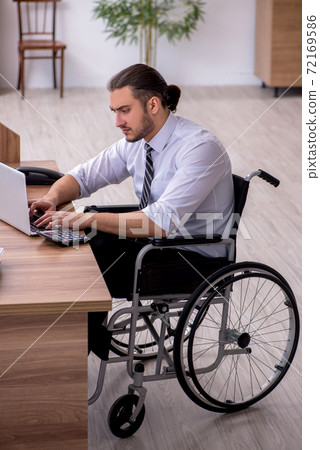 Young disabled employee suffering at workplace Young disabled employee suffering at workplace 72169586