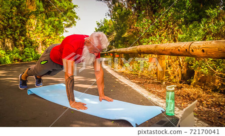 Senior man doing sport exercises 72170041