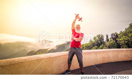Senior man doing sport exercises 72170043