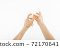 Bottle with antibacterial antiseptic gel in hand on white background 72170641