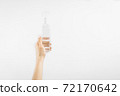 Bottle with antibacterial antiseptic gel in hand on white background 72170642