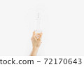 Bottle with antibacterial antiseptic gel in hand on white background 72170643