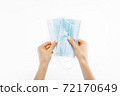 Close up of hand with mask, Surgical mask, on isolated white background, coronavirus disease, COVID-19 72170649