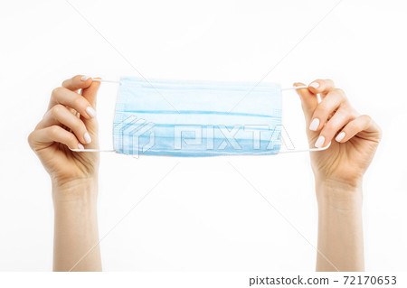 hands holding a mask, protective respiratory mask from the spread of the virus, on a white background 72170653