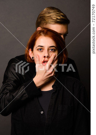 Desparate young woman with aggressive man in studio, domestic violence conception 72170749