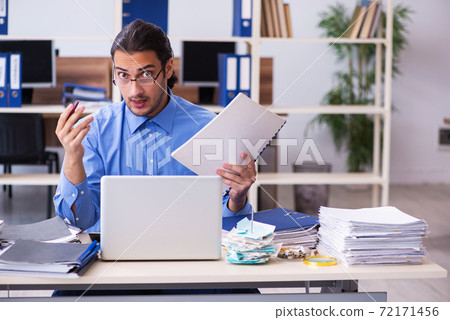 Young male bookkeper in budget planning concept Young male bookkeper in budget planning concept 72171456
