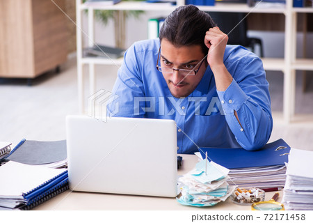 Young male bookkeper in budget planning concept 72171458