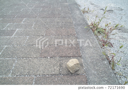 A stone rolling on the edge of the road A stone rolling on the edge of the road 72171690