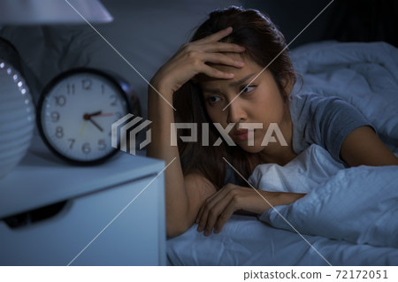 Depressed young woman lying in bed cannot sleep from insomnia 72172051