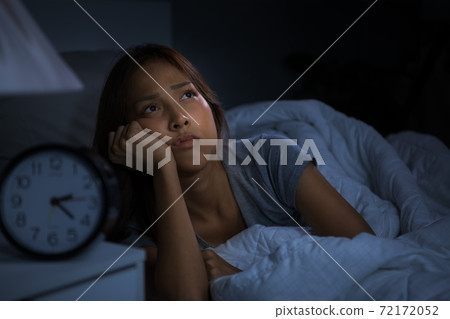 Depressed young woman lying in bed cannot sleep from insomnia 72172052