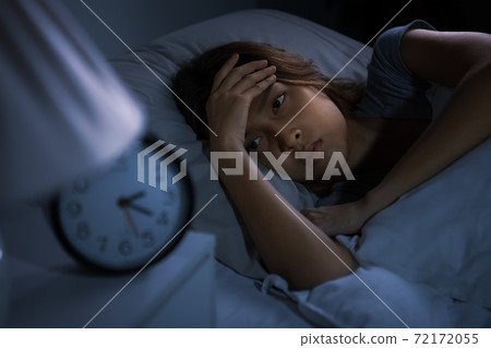 Depressed young woman lying in bed cannot sleep from insomnia Depressed young woman lying in bed cannot sleep from insomnia 72172055