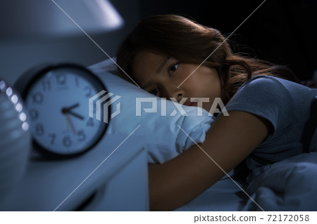 Depressed young woman lying in bed cannot sleep from insomnia 72172058