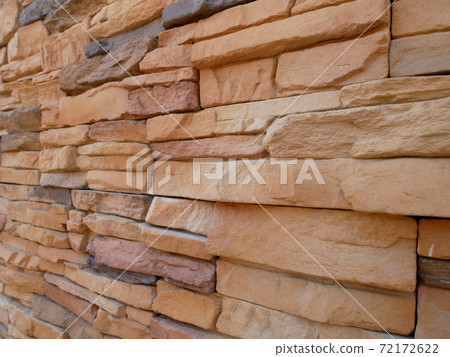 Slate brick in earth tone colour used as wall finishes. Installed overlap according to the method recommended by the manufacturer to get the maximum effect. 72172622