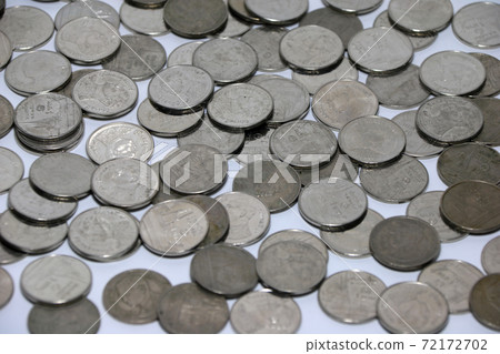 Pattern from Thai coin, one baht spread on the floor. 72172702