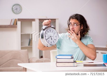 Young male student preparing for exams at home Young male student preparing for exams at home 72172815