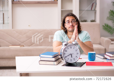 Young male student preparing for exams at home Young male student preparing for exams at home 72172826