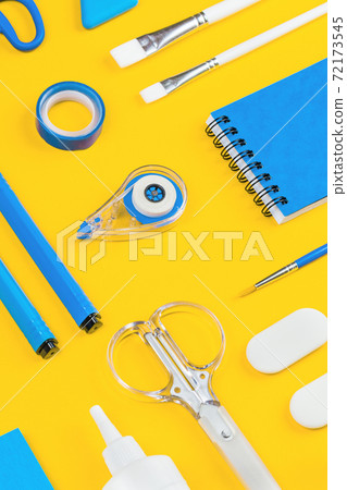 Assorted office and school white and blue stationery on yellow Assorted office and school white and blue stationery on yellow 72173545
