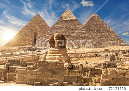 The Sphinx and The Great Pyramids of Giza near the ruins of a temple in Giza, Egypt 72173550